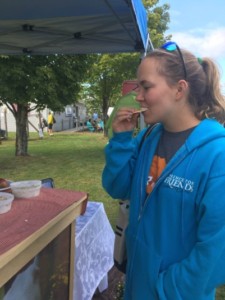 Katie Stevenson ’17 samples cheese from Fredrikson Farmstead. EMILY PINETTE/THE BATES STUDENT