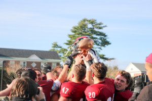 The football team celebrates after their big win against Bowdoin, clinching the CBB title. . SARAH dU PONT/THE BATES STUDENT.