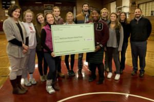 Vantiel Elizabeth Duncan '10 of American Red Cross accepts $1,311.14 check from SAAC on November 10, 2017. PHYLLIS GRABER JENSEN/BATES COLLEGE